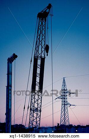Cranes and electric tower in twilight sky View Large Photo Image Stock Photography - Cranes and electric tower in twilight sky. Fotosearch