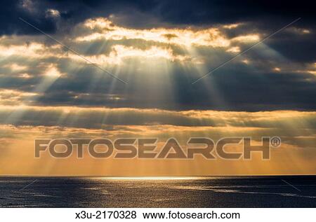 Crepuscular rays, or Jacobs Ladder over Bideford Bay off the North Devon Coast near Westward Ho!, England. View Large Photo Image Stock Photo - Crepuscular rays, or Jacobs Ladder over Bideford Bay off the North Devon Coast near Westward Ho!, England.. Fotosearch