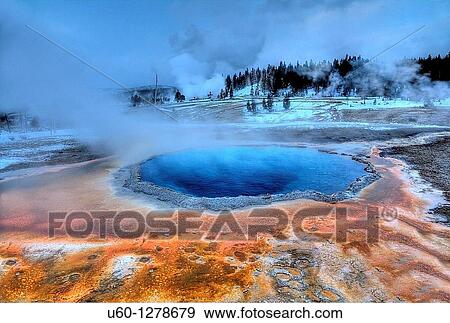 Crested Pool's colors shine during the winter at Yellowstone National Park as Grand Geyser erupts in the background. View Large Photo Image Stock Photo - Crested Pool's colors shine during the winter at Yellowstone National Park as Grand Geyser erupts in the background.. Fotosearch