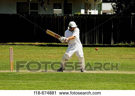 Stock Image - Cricket batsman in action, local club match, Christchurch, New Zealand. Fotosearch