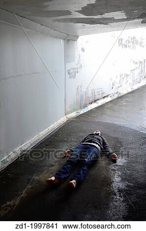 Crime scene concept photo of a murder victim woman lying dead on the ground of a tunnel. View Large Photo Image Stock Image - Crime scene concept photo of a murder victim woman lying dead on the ground of a tunnel.. Fotosearch