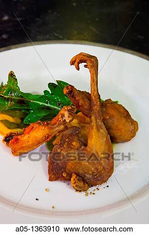 Stock Image - Crispy concert Fried quail, chicken and frog The Eugenia hotel Relais and Chateaux Bangkok Thailand.. Fotosearch