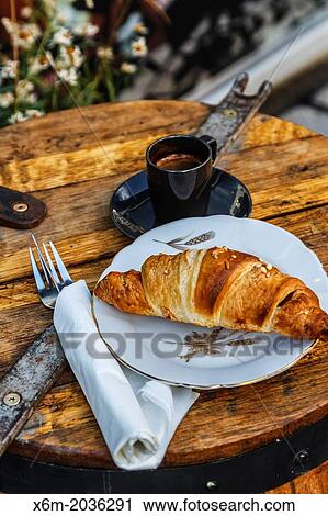 Stock Image - Croissant and coffee. Laugavegur street. Reykjavik. Iceland, Europe.. Fotosearch