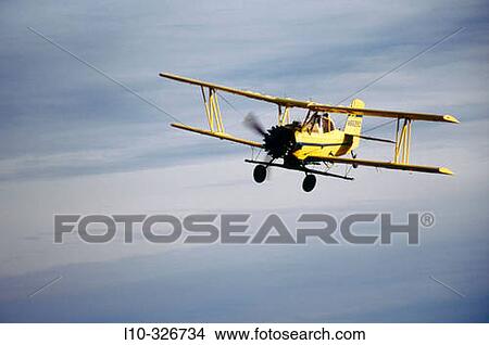Picture - Crop duster approaches for landing at an airstrip just North of Oaksdale. Withman County, Washington, USA. Fotosearch