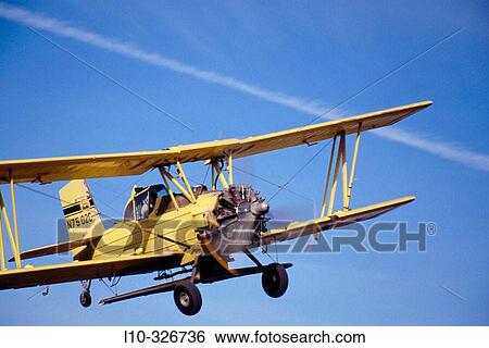 Stock Photograph - Crop duster approaches for landing at an airstrip just North of Oaksdale. Withman County, Washington, USA. Fotosearch