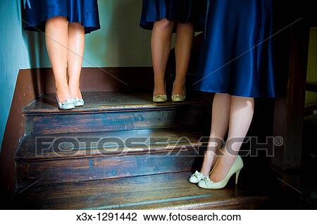 Cropped view of bridesmaids in blue satin dresses standing on stairwell View Large Photo Image Stock Image - Cropped view of bridesmaids in blue satin dresses standing on stairwell. Fotosearch