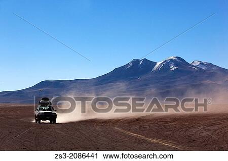 Stock Image - Cross-country vehicle on Salar Uyuni, Salt Desert, Southwest Highlands, Bolivia, South America.. Fotosearch