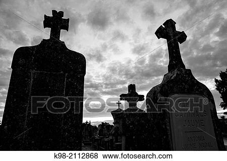 Stock Photo - Cross silhouette at sunset, Cemetery llucmajor, Commemoration of All Souls, popularly known as Dia de Muertos or Day of the Dead, Mallorca, Balearic Islands, Spain.. Fotosearch