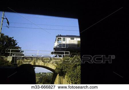 Crossing a bridge in Asturias. Transcantabrian train through the north of Spain View Large Photo Image Stock Photo - Crossing a bridge in Asturias. Transcantabrian train through the north of Spain. Fotosearch