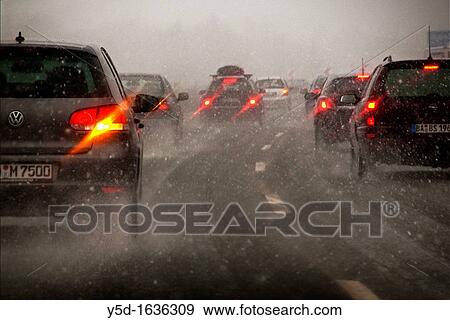 Stock Photo - crowded highway in Germany in severe weather, heavy snowfall. Fotosearch