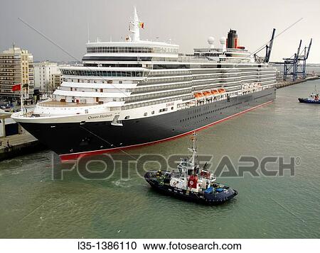 Cruise liner Queen Elizabeth is towed into the port of Cadiz, Spain View Large Photo Image Stock Image - Cruise liner Queen Elizabeth is towed into the port of Cadiz, Spain. Fotosearch