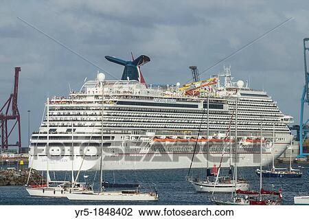 Stock Image - Cruise ship Carnival Breeze maneuvering leaving Las Palmas port on Gran Canaria, Canary Islands, Spain. Fotosearch