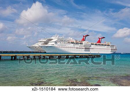 Cruise ship passengers on pier disembarking from Carnival cruise ships Triumph and Ecstasy in Cozumel, Mexico in the Caribbean Sea View Large Photo Image Picture - Cruise ship passengers on pier disembarking from Carnival cruise ships Triumph and Ecstasy in Cozumel, Mexico in the Caribbean Sea. Fotosearch