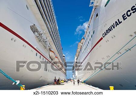 Cruise ship passengers on pier disembarking from Carnival cruise ships Triumph and Ecstasy in Cozumel, Mexico in the Caribbean Sea View Large Photo Image Stock Image - Cruise ship passengers on pier disembarking from Carnival cruise ships Triumph and Ecstasy in Cozumel, Mexico in the Caribbean Sea. Fotosearch