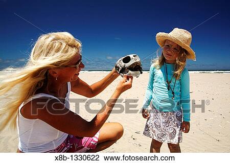 Stock Image - CT and Grace on the beach with dead turtles Turtle researchers from the NGO Pro Caguama study and capture the critically endangered Loggerhead Turtle Caretta caretta from the town of Puerto Lopez Mateos. Fotosearch