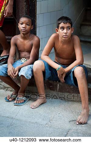 Cuba, Havana, boys sitting on sidewalk View Large Photo Image Stock Image - Cuba, Havana, boys sitting on sidewalk. Fotosearch