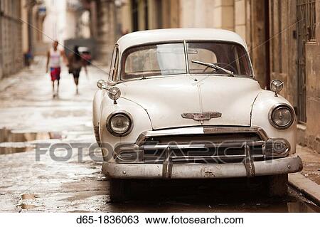 Cuba, Havana, Havana Vieja, morning view of Old Havana street with 1950s-era US car View Large Photo Image Stock Image - Cuba, Havana, Havana Vieja, morning view of Old Havana street with 1950s-era US car. Fotosearch