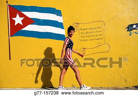 Cuba, Havana. Young woman w. american-flag suit walking close to wall with cuban flag and poem of Jose Marti View Large Photo Image Stock Photo - Cuba, Havana. Young woman w. american-flag suit walking close to wall with cuban flag and poem of Jose Marti. Fotosearch