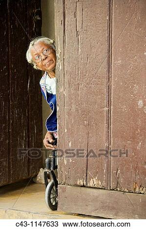Cuba - Old woman on a wheelchair at the front door of her house in Habana Vieja, the Old Town of Cuba's capital Havana View Large Photo Image Stock Image - Cuba - Old woman on a wheelchair at the front door of her house in Habana Vieja, the Old Town of Cuba's capital Havana. Fotosearch