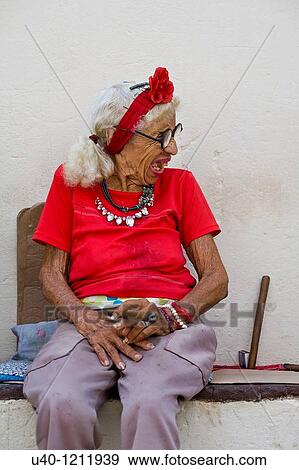 Stock Photo - Cuba, old woman smoking cigar. Fotosearch