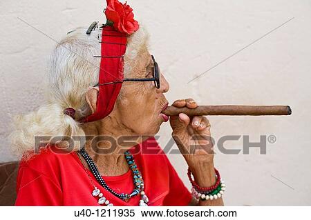 Cuba, Old woman smoking cigar View Large Photo Image Stock Photography - Cuba, Old woman smoking cigar. Fotosearch