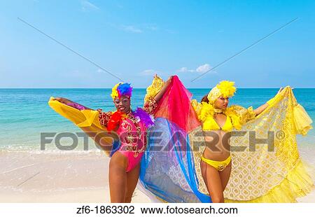 Stock Image - Cuba, Trinidad, Dancers in costumes on beach. Fotosearch