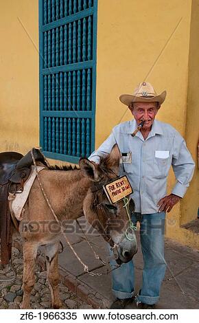 Cuba Trinidad old man with cowboy hat with donkey for rides in center of old colonial city. View Large Photo Image Stock Photography - Cuba Trinidad old man with cowboy hat with donkey for rides in center of old colonial city.. Fotosearch