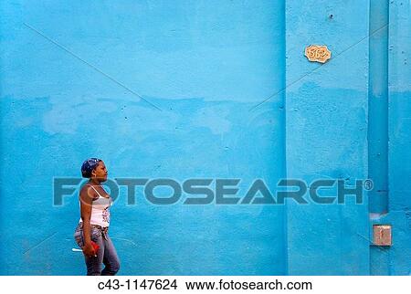 Cuba - Woman walking past a brightly blue painted fa? ade in Habana Vieja, the Old Town of Cuba's capital Havana View Large Photo Image Picture - Cuba - Woman walking past a brightly blue painted fa? ade in Habana Vieja, the Old Town of Cuba's capital Havana. Fotosearch