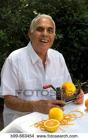 CUBAN MAN PEELING ORANGES MIAMI, FLORIDA USA View Large Photo Image Picture - CUBAN MAN PEELING ORANGES MIAMI, FLORIDA USA. Fotosearch