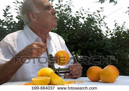 CUBAN MAN PEELING ORANGES MIAMI, FLORIDA USA View Large Photo Image Stock Photo - CUBAN MAN PEELING ORANGES MIAMI, FLORIDA USA. Fotosearch