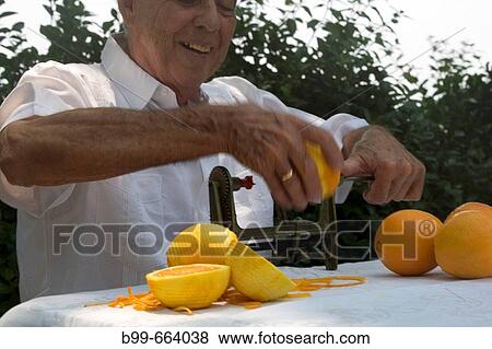 CUBAN MAN PEELING ORANGES MIAMI, FLORIDA USA View Large Photo Image Stock Photo - CUBAN MAN PEELING ORANGES MIAMI, FLORIDA USA. Fotosearch