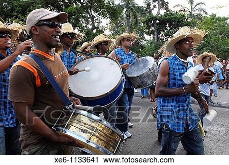 Stock Image - Cuban musicians playing drums during a parade held in Havana Cuba. Fotosearch