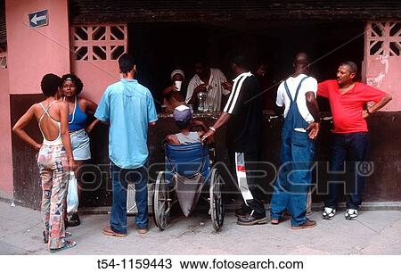 Stock Image - Cubans in a street bar in Havana. Fotosearch