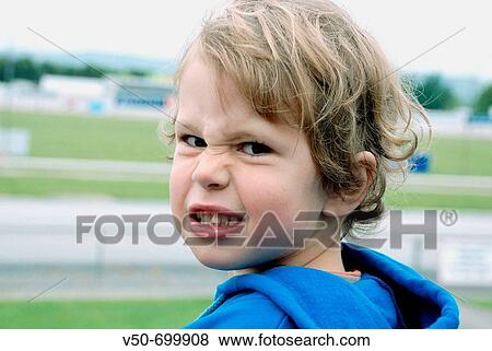 Cude blond guy with a funny-anger look in the trots horse an dogs racing course in Cambridge, New Zealand, blue hoddy sweater View Large Photo Image Stock Photo - Cude blond guy with a funny-anger look in the trots horse an dogs racing course in Cambridge, New Zealand, blue hoddy sweater. Fotosearch