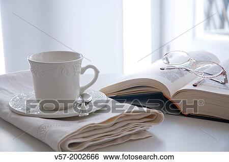 Stock Photograph - Cup, book and eyeglasses.. Fotosearch