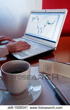 Stock Image - Cup of Coffee and Laptop on Armchair. Fotosearch