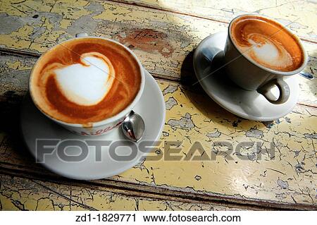 Cups of hot flat white coffee drinks on an old wooden table in a cafe View Large Photo Image Stock Image - Cups of hot flat white coffee drinks on an old wooden table in a cafe. Fotosearch