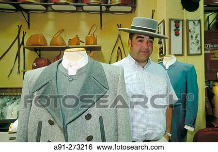 Stock Photograph - Customer in a shop selling traditional andalucian men's garments and hats. Seville. Andalucia. Spain. Fotosearch