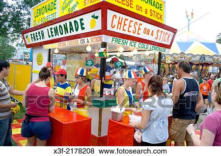 Customers buying lemonade and cheese on a stick at a garish concession stand. Minnesota State Fair St Paul Minnesota MN USA. View Large Photo Image Stock Photo - Customers buying lemonade and cheese on a stick at a garish concession stand. Minnesota State Fair St Paul Minnesota MN USA.. Fotosearch