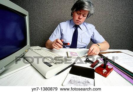 customs officer at work checking passports and stamping her approval View Large Photo Image Stock Photo - customs officer at work checking passports and stamping her approval. Fotosearch