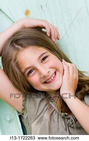 Cute 8-years girl with an arm over-head View Large Photo Image Stock Image - Cute 8-years girl with an arm over-head. Fotosearch