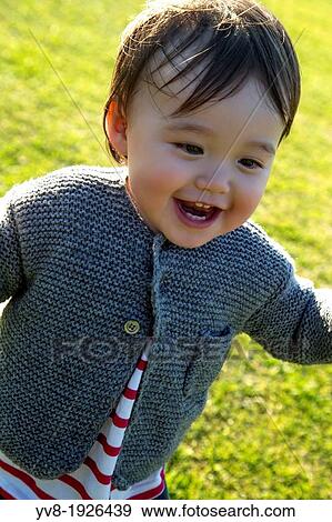 Cute baby girl running on the lawn View Large Photo Image Stock Photo - Cute baby girl running on the lawn. Fotosearch