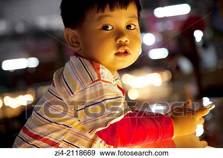 Cute Cambodian kid in a market in Siem Reap Cambodia. View Large Photo Image Stock Photo - Cute Cambodian kid in a market in Siem Reap Cambodia.. Fotosearch