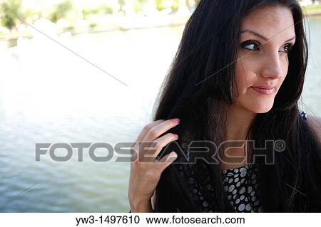 Cute face of 25 year old pretty woman outdoors near pond View Large Photo Image Stock Image - Cute face of 25 year old pretty woman outdoors near pond. Fotosearch