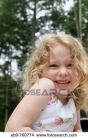 Picture - Cute girl smiling at the camera. Fotosearch