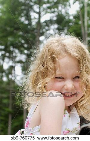 Cute girl smiling at the camera View Large Photo Image Stock Photography - Cute girl smiling at the camera. Fotosearch