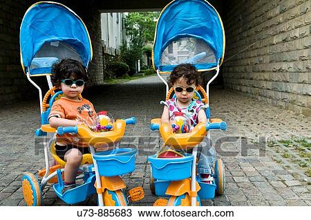 Cute Twins wearing sunglasses View Large Photo Image Stock Image - Cute Twins wearing sunglasses. Fotosearch