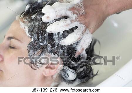 Cute woman having his hair washed in a hairdressing salon View Large Photo Image Stock Photograph - Cute woman having his hair washed in a hairdressing salon. Fotosearch