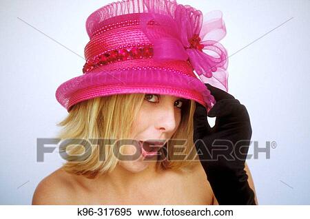 Stock Photography - cute young woman and pink hat. Fotosearch
