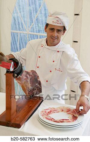 Stock Image - Cutting ham. Wedding. Divinus Catering, San Sebastian, Donostia, Gipuzkoa, Euskadi. Spain.. Fotosearch